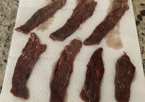 Marinated beef strips laid separately on paper towels