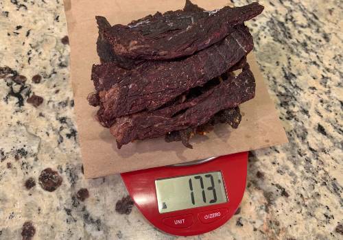 Finished jerky on a scale reading 173 grams