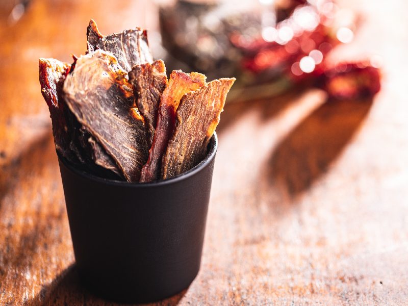 Dried meat strips standing in a black cup