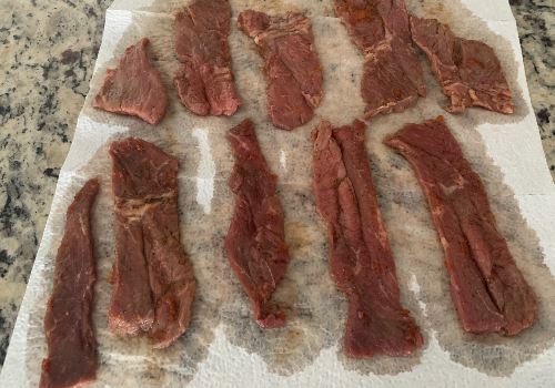 Marinated beef strips arranged on paper towels