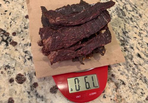 Homemade jerky on a scale reading 6.1 ounces