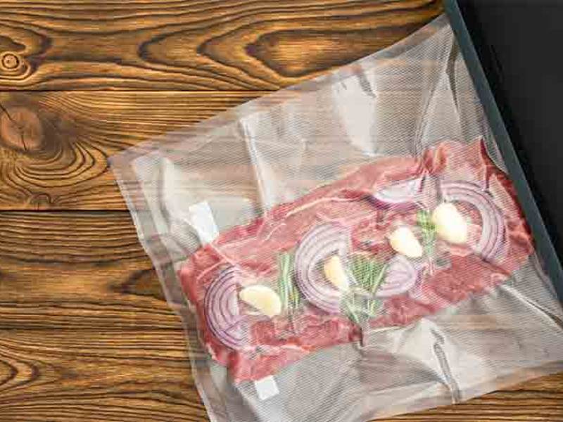Raw meat, onion, and herbs sealed in a vacuum bag