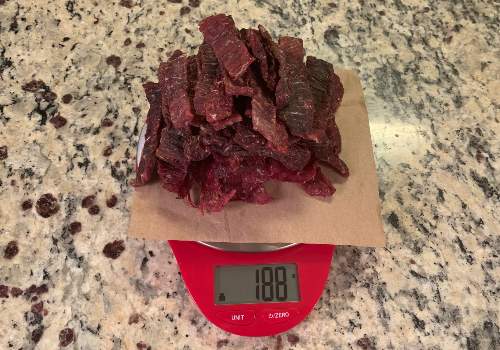Finished honey-peppered jerky on a scale reading 188 grams