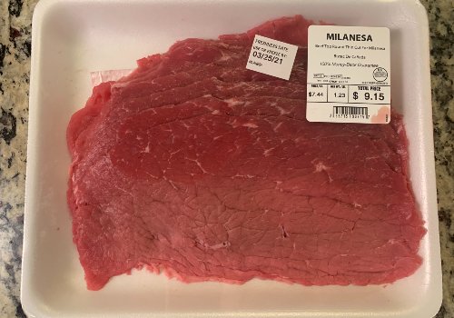 Packaged thin-cut top round labeled Milanesa