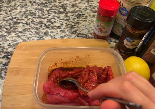 Beef being stirred through a red chile marinade
