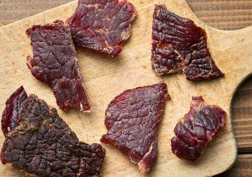 Thin beef jerky pieces laid on parchment