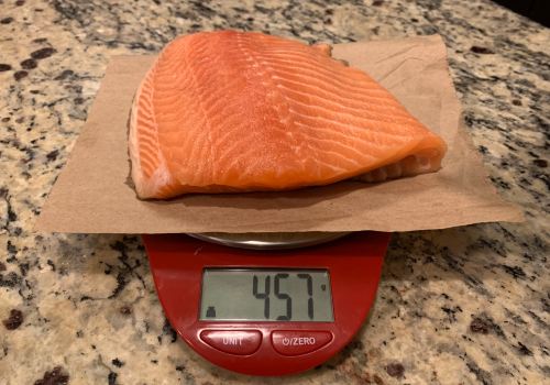 A salmon fillet weighed with the scale set to grams