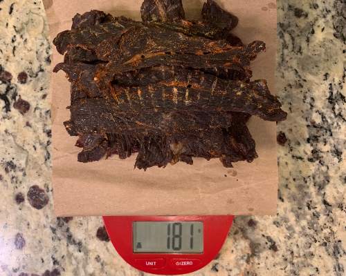 Finished jerky on a scale reading 181 grams