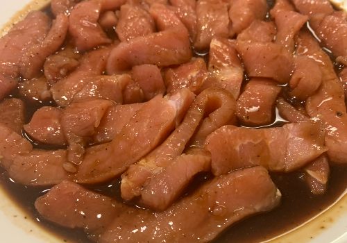 Pork strips coated in a brown marinade