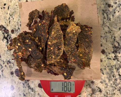 Finished beef jerky on a scale set to grams