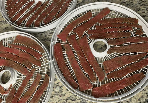 Beef jerky placed on the dehydrator  