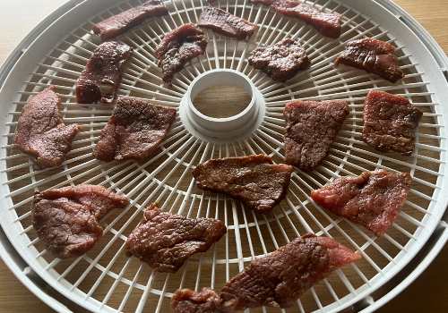 Beef is placed on the dehydrator before drying