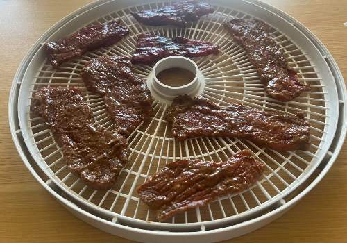 Classic BBQ Beef Jerky placed on the dehydrator for drying