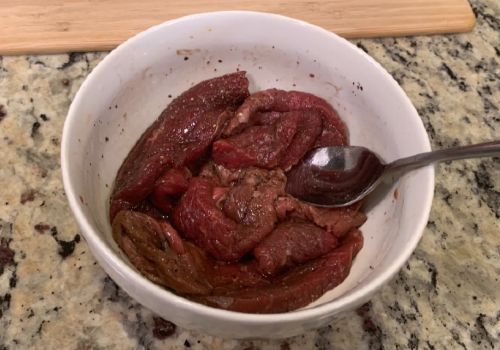 Mixing the marinade and meat for basic beef jerky