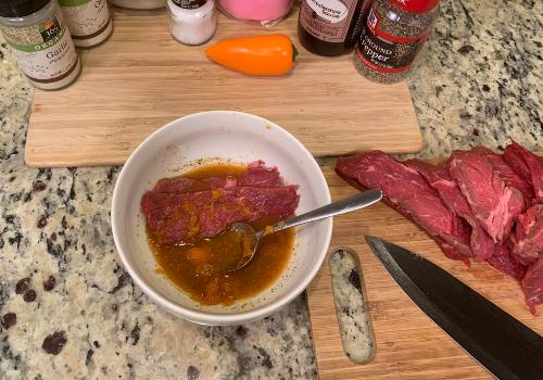 Mixing the marinade and meat for homemade beef jerky