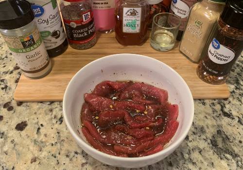 Mixing the marinade and meat for honey peppered beef jerky