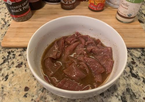 Mixing the marinade and meat for hot beef jerky 