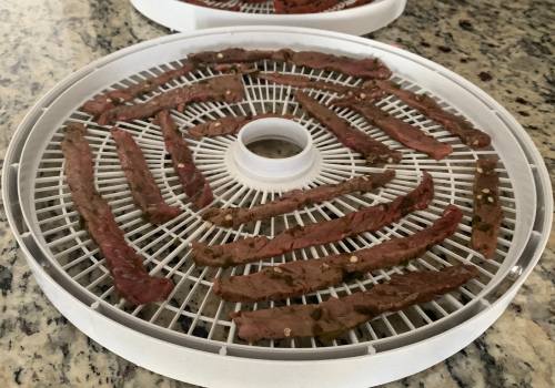 South texas jalapeno jerky placed on the dehydrator for drying