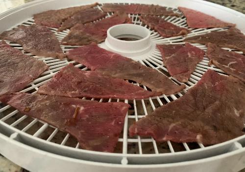 Beef placed on the dehydrator